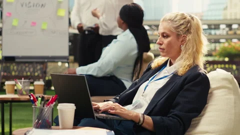 Office employee taking notes on laptop during outdoor planning meeting Stock Footage 338382217