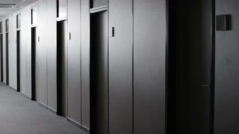 Office employee walking through corridor and turning the lights off Stock Footage 78210336