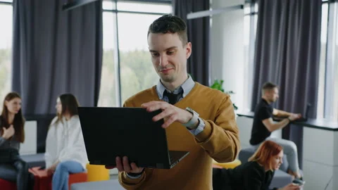 Office employees during work in the open space.Male office manager closes laptop Stock Footage 236986922