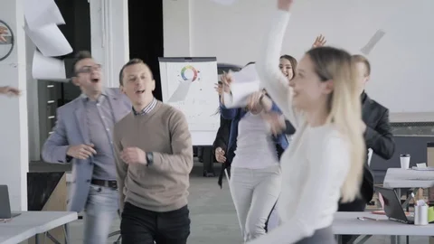 Office employees got up from workplaces, threw away documents, and happy Stock Footage 124705812