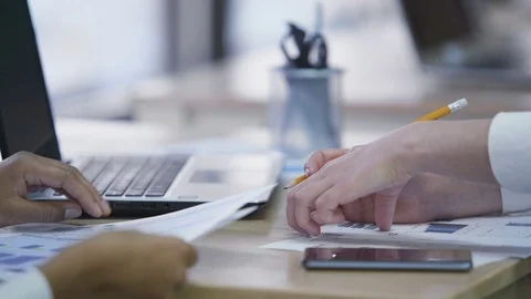 Office employees preparing statistical report together, checking diagrams Stock-Footage 70856778