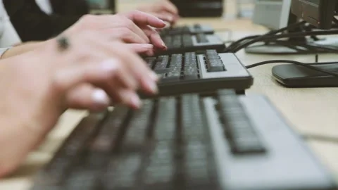 Office employees typing on a keyboard. In the frame, multiple keyboards and hand 스톡 동영상 222431325