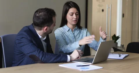 Office employees working in team use laptop, discuss collaborative task Stock Footage 229683672