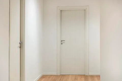 Office entrance with white wooden doors and wood flooring Stock Photos