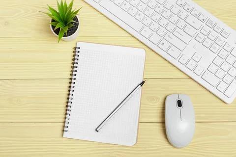 Office equipment such as computer keyboard and other supplies on wooden table Foto stock