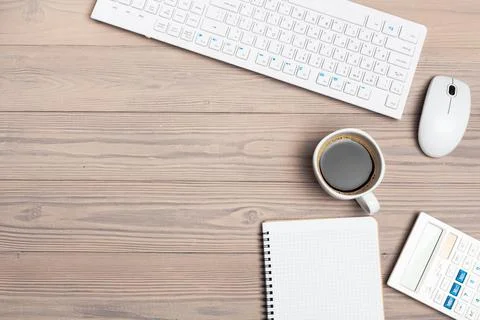 Office equipment such as computer keyboard and other supplies on wooden table Foto stock