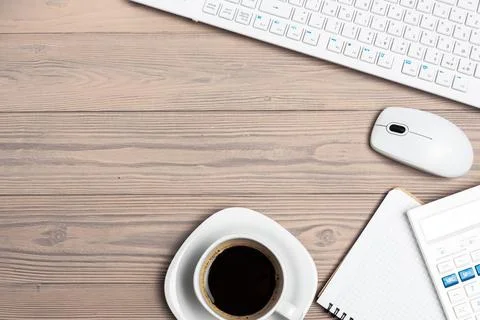 Office equipment such as computer keyboard and other supplies on wooden table Foto stock