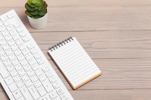 Office equipment such as computer keyboard and other supplies on wooden table Foto stock