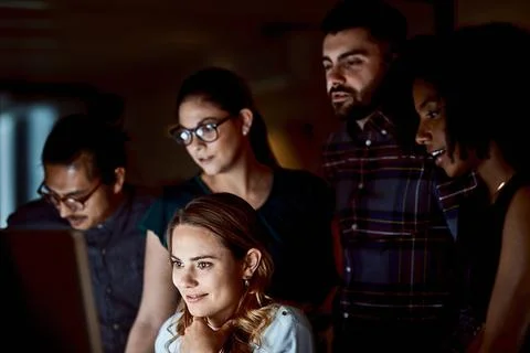 Office, group and smile with computer at night, collaboration and discussio.. Stock Photos