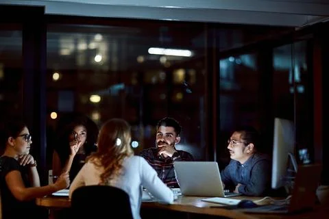 Office, group and talk with paperwork at night, collaboration and discussio.. Stock Photos