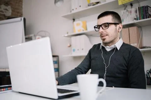 Office guy communicates with colleagues via internet Stock Photos
