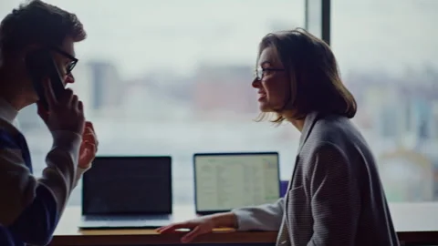 Office guy talking mobile phone panoramic hall closeup. Colleagues giving five Stock Footage 335244405