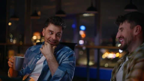 Office guys having fun evening cityscape room closeup. colleagues drinking tea Stock Footage 339300091