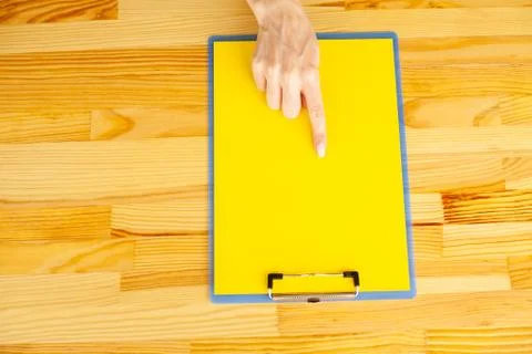 Office Hand Holding a Folder with a Red Color Paper and Pen on the Background of Stock Photos