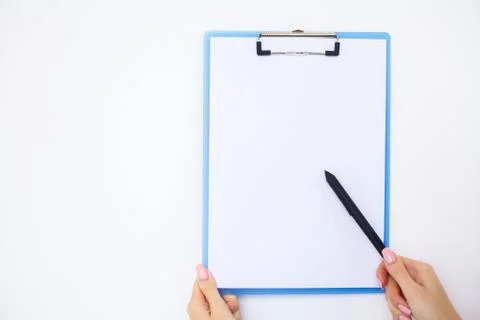 Office Hand Holding a Folder with a White Color Paper on the Background of the Foto stock