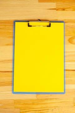 Office Hand Holding a Folder with a Yellow Color Paper on the Background of the Stock Photos