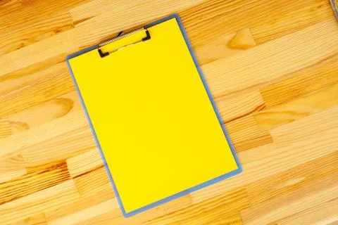 Office Hand Holding a Folder with a Yellow Color Paper on the Background of the Stock Photos