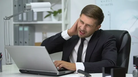Office head working on laptop, suffering strong pain in neck, inflammation Stock Footage 117189953