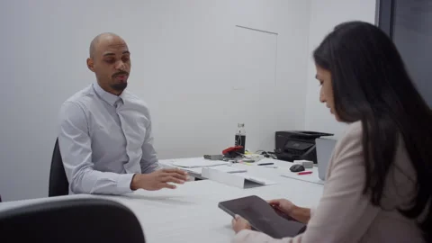 Office job interview, a female manager discussing with a motivated male Stock Footage 296281973