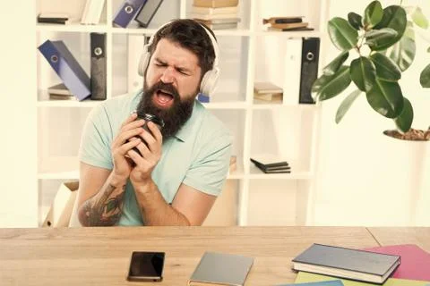 Office life rhythm. Regular office day. Man bearded guy headphones sit office Stock Photos