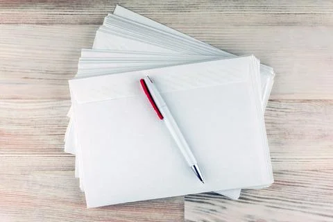 Office mail: a pack of white empty blank envelopes for letters and white ball Stock Photos