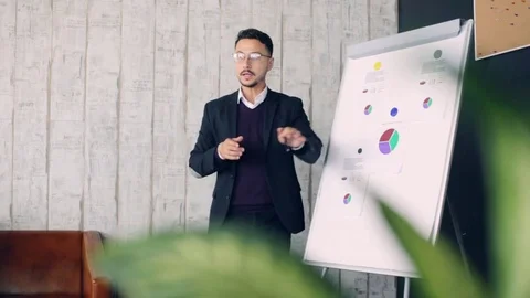 Office man presenting to team taking notes in boardroom. Stock Footage 80904937