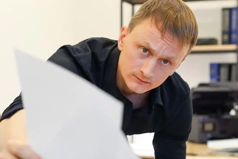 Office man presenting two blank sheets forward 写真素材