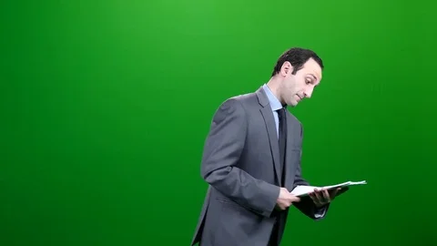 Office Man Reading a Report on Green Screen Stock-Footage 83737585