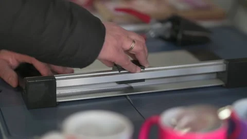 Оffice man using manual paper cutter or paper trimmer tool cutting white paper Stock Footage 168936265