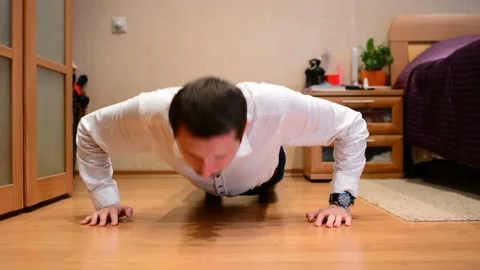 Office manager doing push-ups in at home Stock Footage 91187367