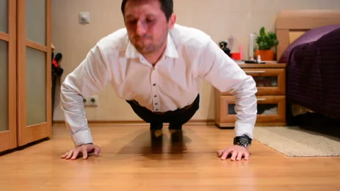Office manager doing push-ups in at home Stock Footage 91188496
