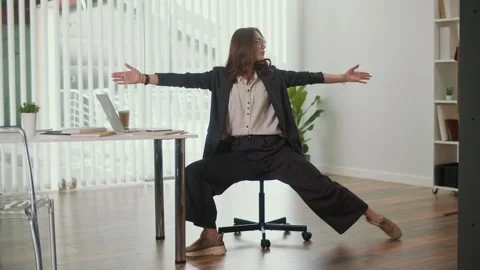 Office Manager Doing Side Leg Stretch for Lumbar Spine Health in Office Stock Footage 318236154