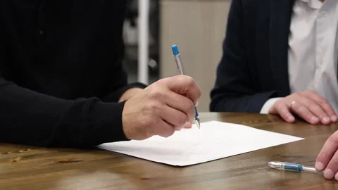 An office manager draws a work plan on paper with a pen Stock Footage 340558825