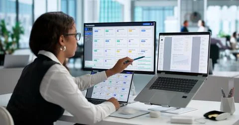 Office Manager Efficiently Organizes Digital Files Using Secure Cloud System. Stock Photos