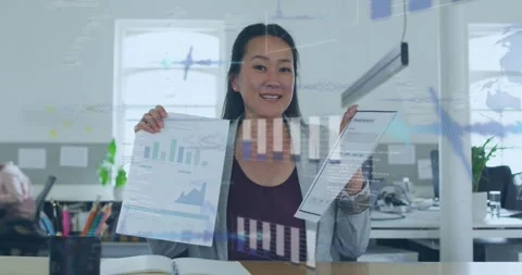 Office manager holding two reports and comparing charts while projecting Stock Footage 321549866