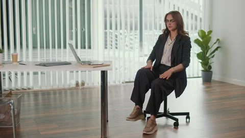 Office Manager Practicing Seated Hip Stretch for Lumbar Spine in Hybrid Work Stock Footage 318483940