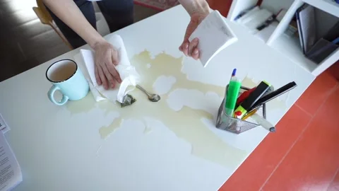 Office manager Spilled Tea On The Work Desk. Cleaning The work Place Stock Footage 148126887