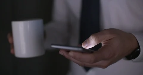 Office manager working late scrolling through messages on smart phone. Night, 4k Stock-Footage 90571889