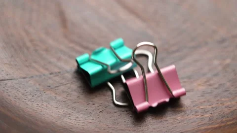 Office metal binder clips falling into container 스톡 동영상 316615319
