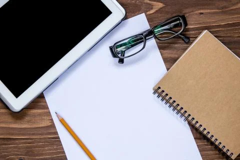 Office objects set on the table. Examination pad and pencil, glasses and note Stock Photos