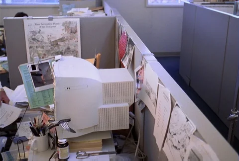 Office partitions are seen as the camera dollies left into one cubicle where a Stock Footage 86774155