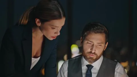 Office partners working late solving business problem. Closeup boss discussing Foto stock