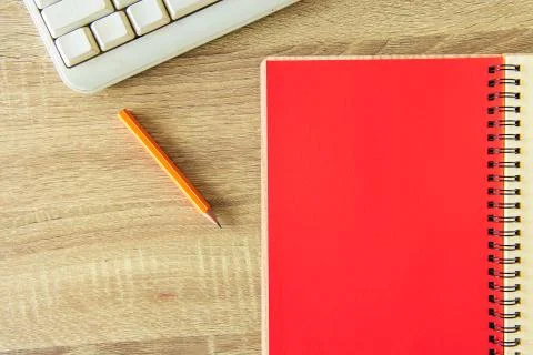 Office pattern red paper notebook pencil and computer keyboard on table simpl 写真素材