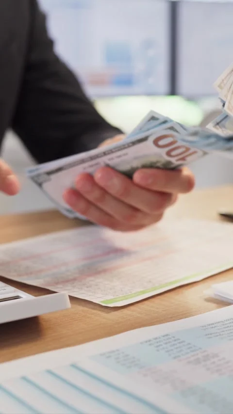 Office payroll payment with employees counting cash and finance documents on Stock Footage 343608817