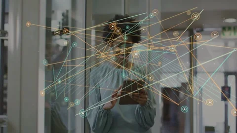 Office pro tapping tablet and causing node network growing across glass, hiding Stock Footage 333078234
