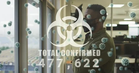 Office pro at window watching biohazard overlay animating TOTAL CONFIRMED Stock Footage 323432140