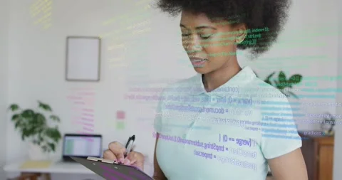 Office professional writing notes while code overlays guiding tech analysis with Stock Footage 330732968