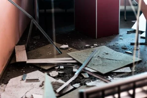 In the office room, the ceiling collapsed after an explosion or an earthquake Stock Photos