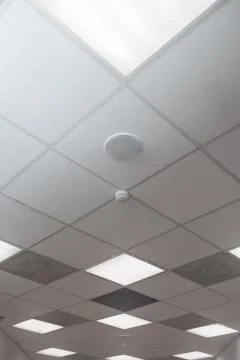 Office room ceiling with smoke detector and alarm Stock Photos