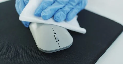 Office sanitizing wipe wiping mouse and mousepad with disinfecting wipes Video stock 126895458